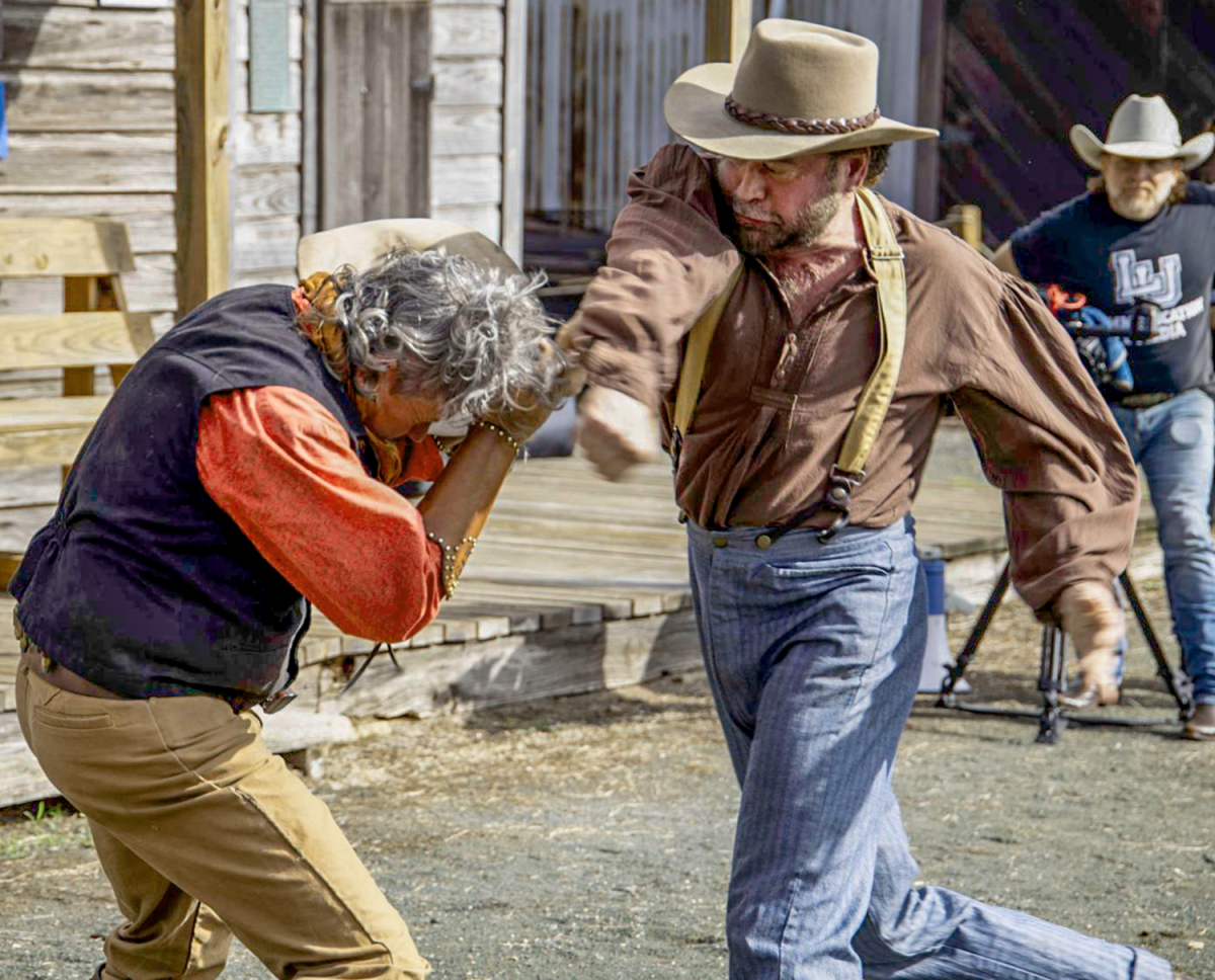 Actors Bit Pruitt, left, and Jody Nolan begin “brawling” during a staged fight in their indie film at Spindletop-Gladys city Boomtown Museum near Lamer University on Oct. 6.