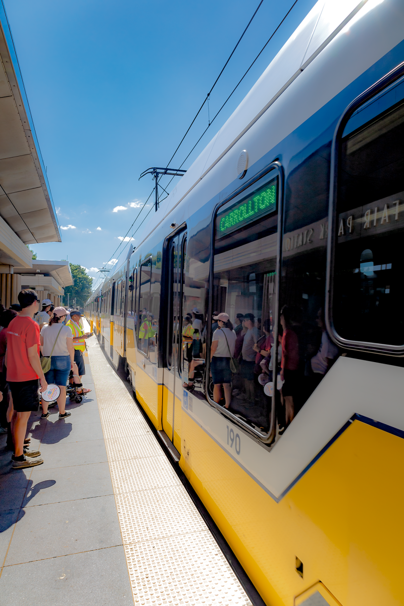 A green line DART rail train travels to North Carrollton at the State Fair of Texas stop.