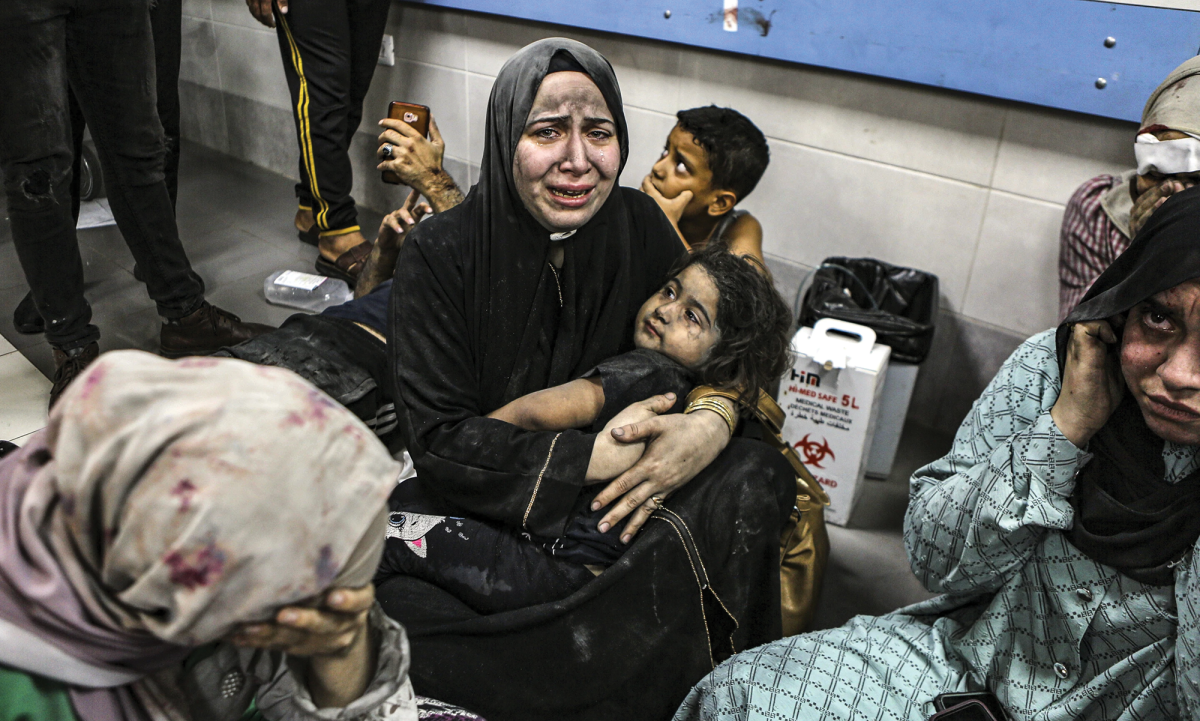 Wounded Palestinians sit in Shifa Hospital in Gaza City after arriving from al-Ahli Hospital after an explosion there on Oct. 17.