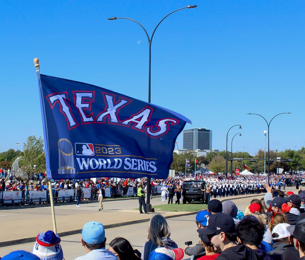 A Rangers flag is flown in celebration at their World Series victory parade in Arlington.