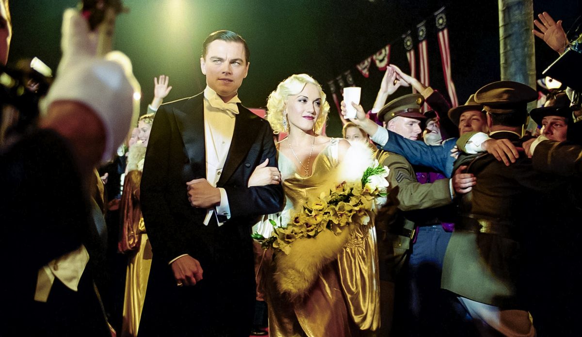 Leonardo DiCaprio starring as Howard Hughes with Gwen Stefani as Jean Harlow attending a party together in The Aviator.