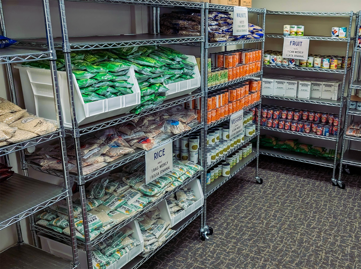The+shelves+of+the+Food+Pantry%2C+stocked+with+donated+food+like+beans%2C+rice%2C+and+cans+of+vegetables.