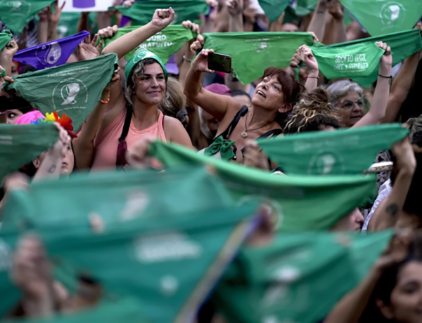 Women hold up green bandanas, a symbol of abortion rights in Latin America, during International Women’s Day march in Buenos Aires on March 8.