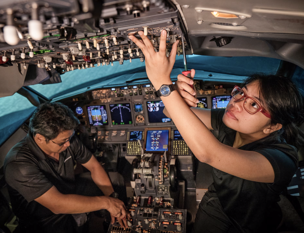 Boeing mechanics work in the cabin while building a plane.