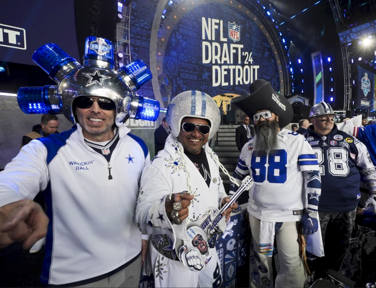 Dallas Cowboys fans pose ahead of the first round of the NFL football draft on April 25 in Detroit.