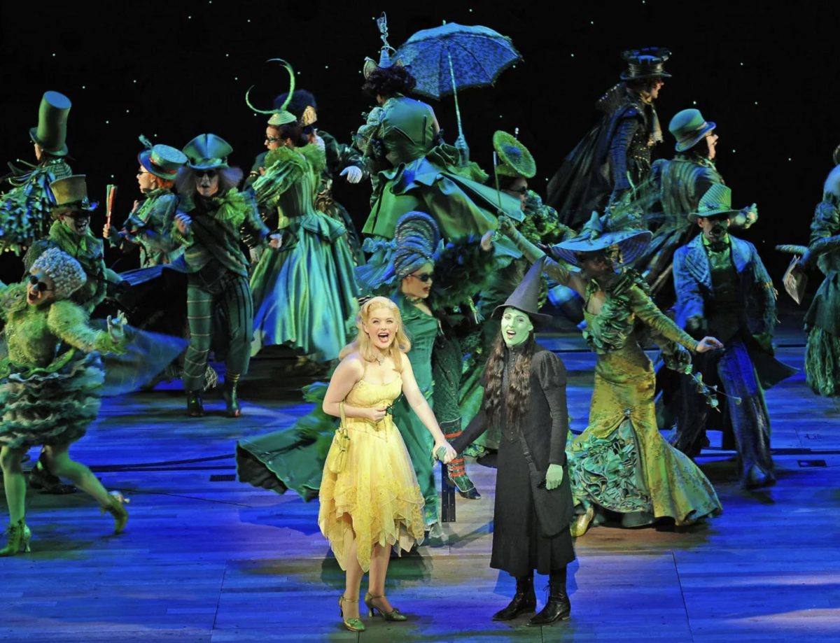 Lucy Durack as Galinda and Amanda Harrison as Elphaba performing with the cast of “Wicked.”