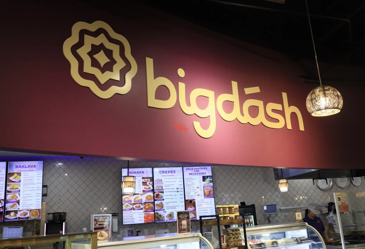 The “Bigdásh” sign above the kitchen is lit with suspended lanterns.