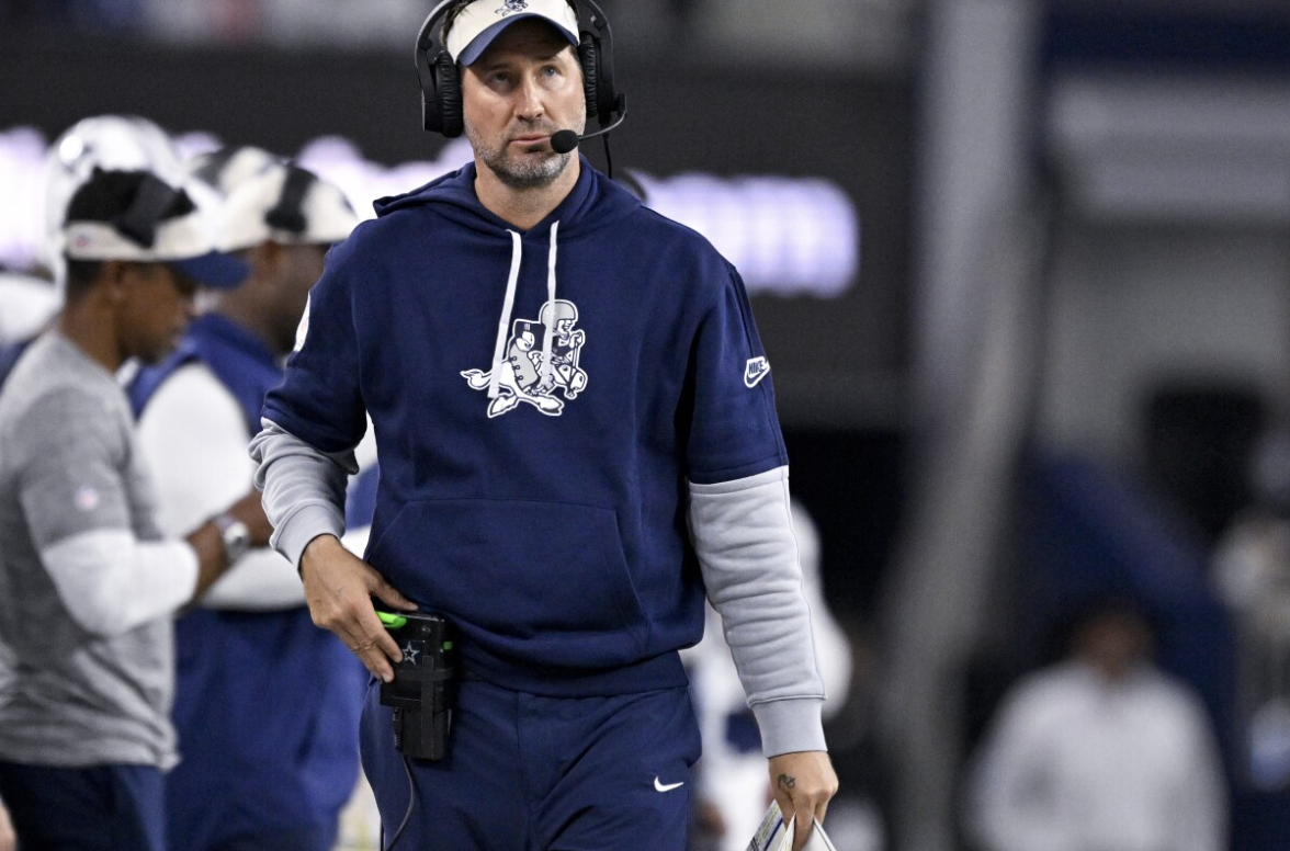 Dallas Cowboys offensive coordinator looks on from the sidelines during an NFL football game  in Arlington, Texas.