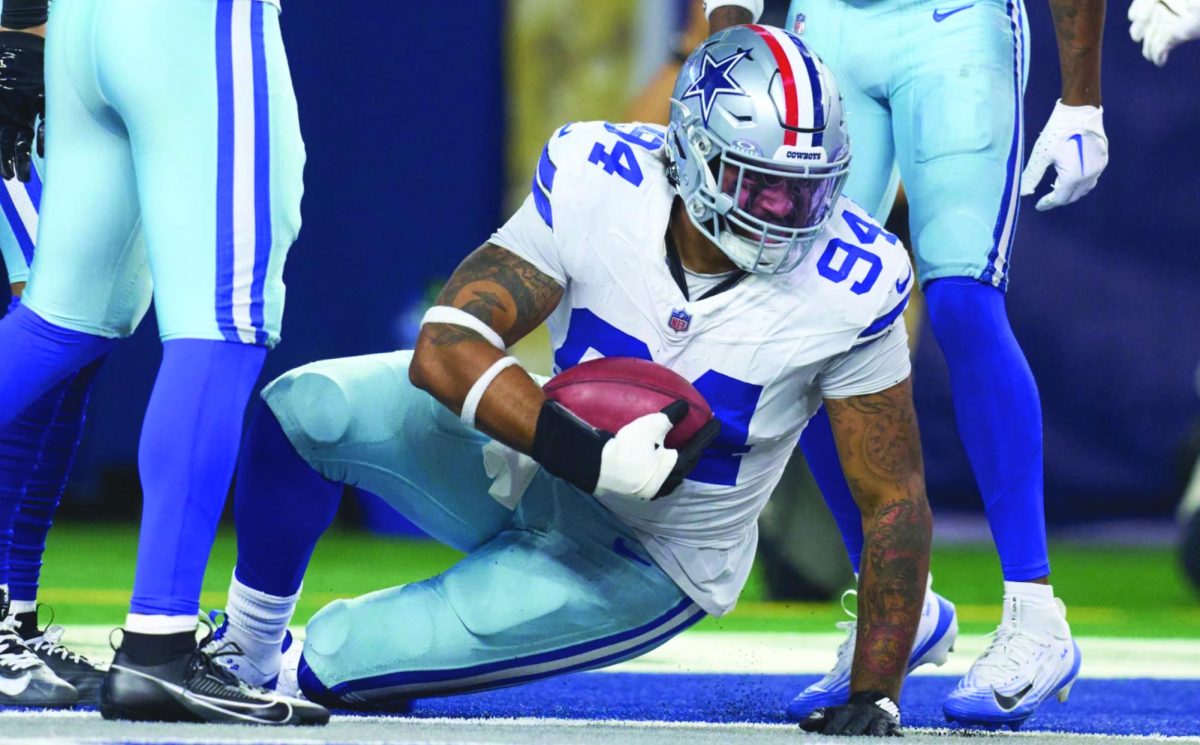 Marshawn Kneeland holds football after recovering from injury during NFL football game.