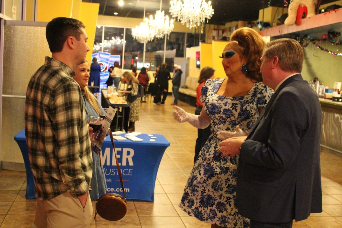 Judge candidate Nicholas Palmer (right) speaks with drag performers and attendees at his drag show fundraiser ahead of the March 3 primary elections.
