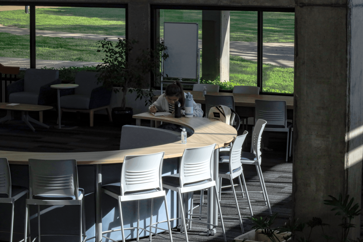 Student Sivchheng Sam sits at a new table installed in the Learning Commons.