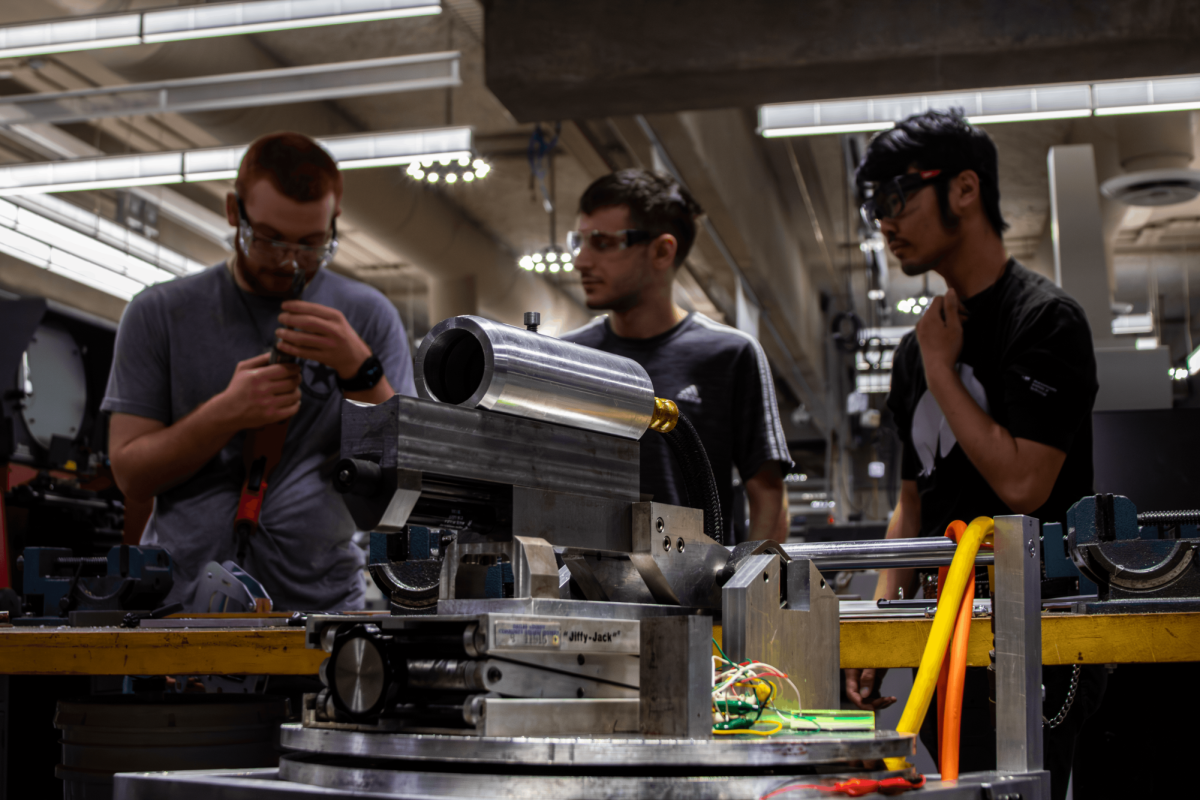 From left: Caleb Walters, Denis Lakovic and Phu Luu work on their rocket launcher. 